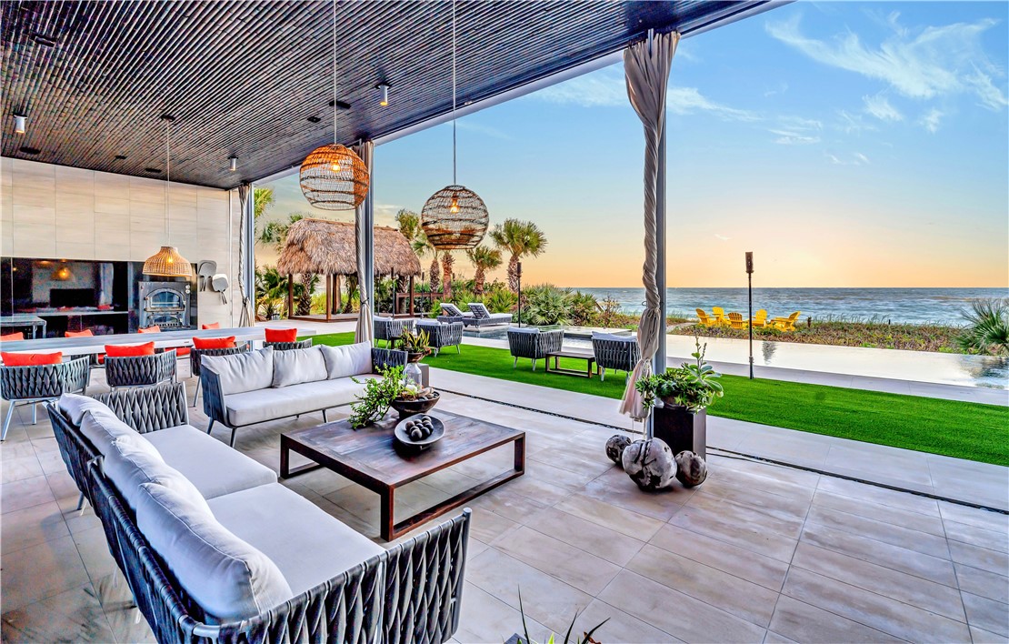 3700 Ocean Drive Vero Beach, FL 32963 - Photo 16 of 36 a view of a patio with a table chairs and a garden