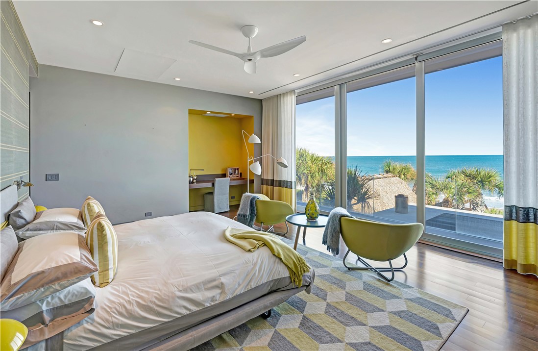 3700 Ocean Drive Vero Beach, FL 32963 - Photo 28 of 36 a bed sitting in a bedroom next to a window