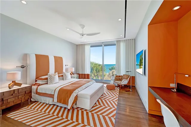 a bedroom with double bed and a large window