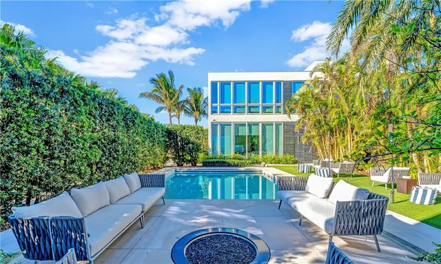 a view of a patio with couches table and chairs and potted plants