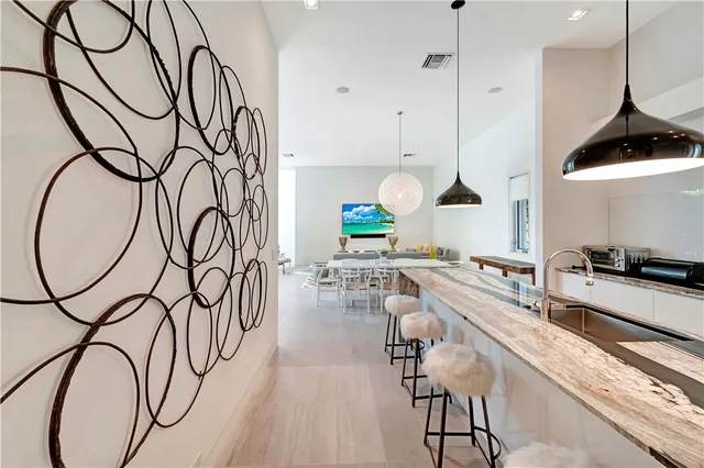 a very nice looking room with a lots of white furniture