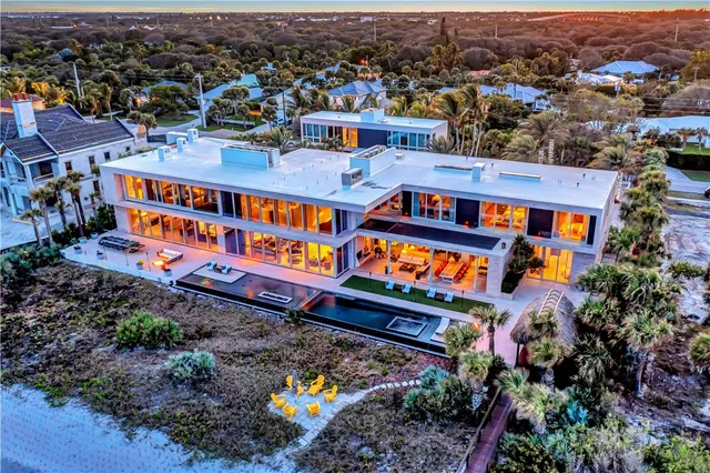 an aerial view of a houses with swimming pool
