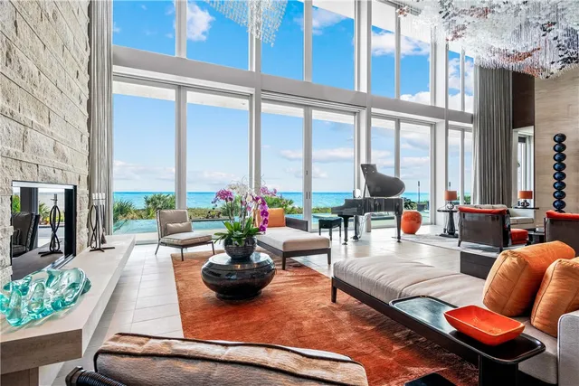 a living room with patio furniture and a floor to ceiling window