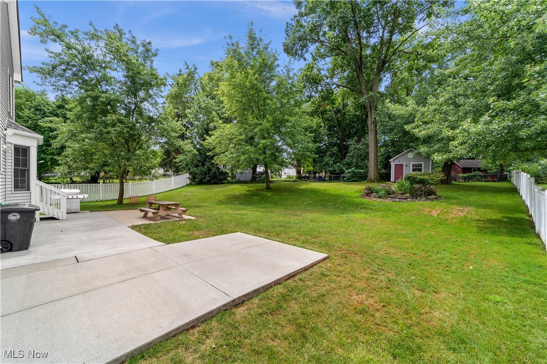 4500 Brooks Road Cleveland, OH 44105 - Photo 40 of 50 Fenced yard featuring a patio, an outbuilding, and view of wooded area