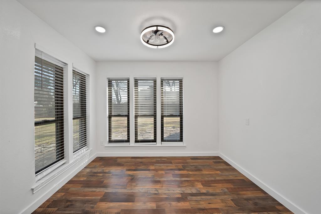 3410 Faulkner Drive Rowlett, TX 75088 - Photo 16 of 38 a view of an empty room with a window and wooden floor