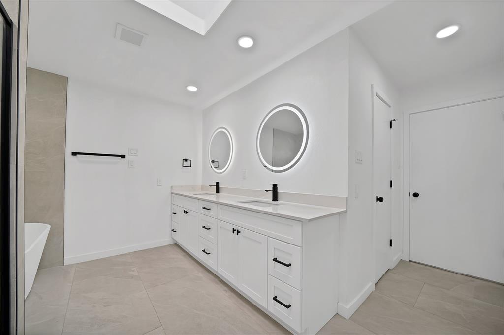 3410 Faulkner Drive Rowlett, TX 75088 - Photo 28 of 38 a bathroom with a sink a mirror and a shower
