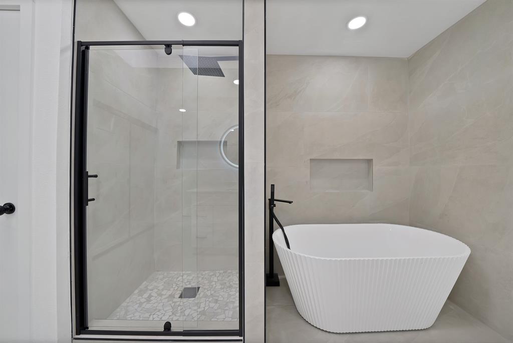 3410 Faulkner Drive Rowlett, TX 75088 - Photo 29 of 38 a bathroom with a white bath tub