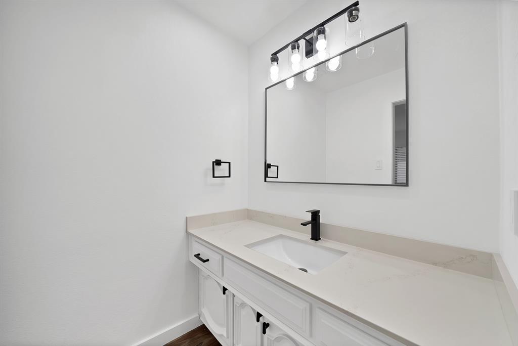 3410 Faulkner Drive Rowlett, TX 75088 - Photo 31 of 38 a bathroom with a sink and a mirror