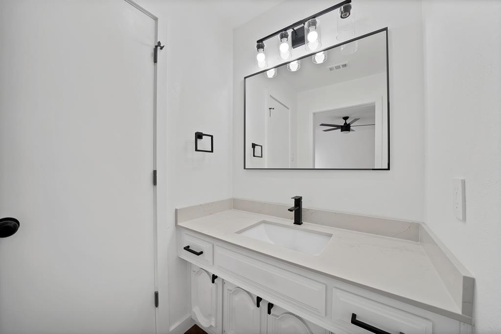 3410 Faulkner Drive Rowlett, TX 75088 - Photo 32 of 38 a bathroom with a sink and a mirror