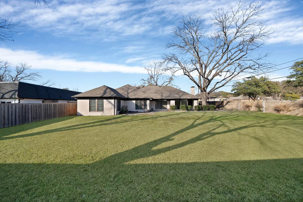 3410 Faulkner Drive Rowlett, TX 75088 - Photo 35 of 38 a front view of a house with a big yard