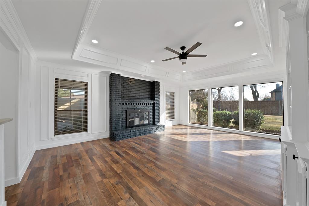 3410 Faulkner Drive Rowlett, TX 75088 - Photo 5 of 38 a view of an empty room with a fireplace and a window