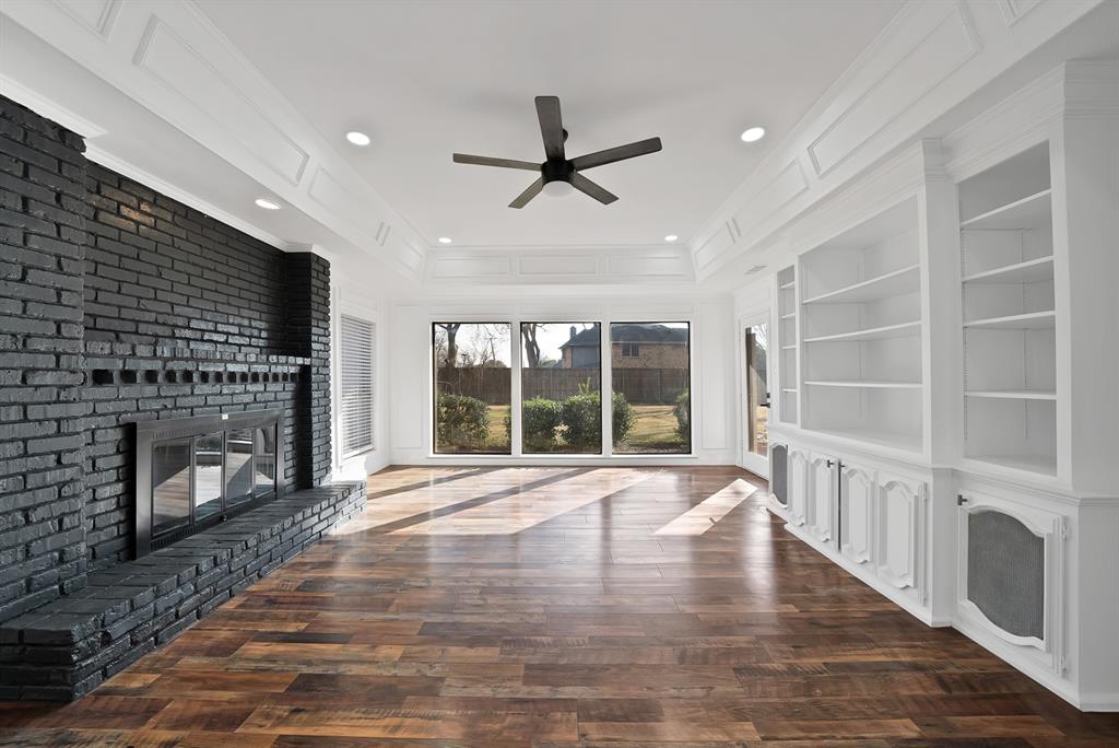 3410 Faulkner Drive Rowlett, TX 75088 - Photo 6 of 38 an empty room with windows and fireplace