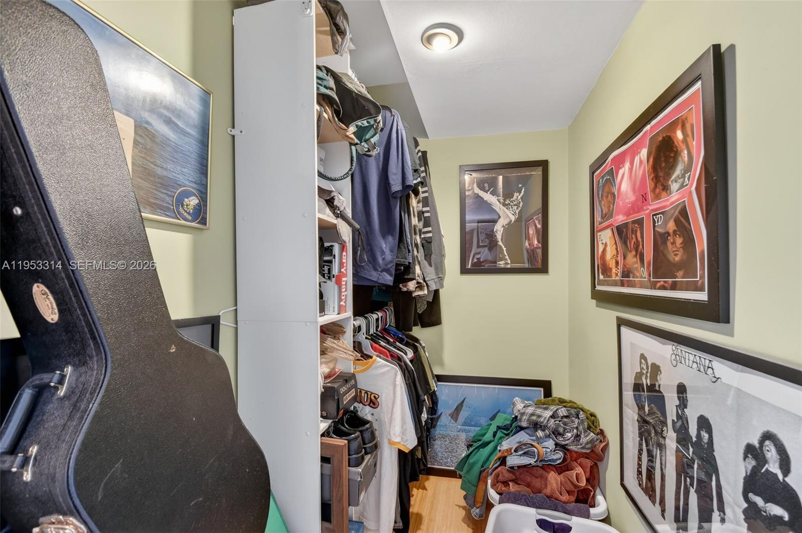 1712 High Ridge Road Lake Worth, FL 33461 - Photo 13 of 43 a view of a hallway with paintings on the wall and a large mirror