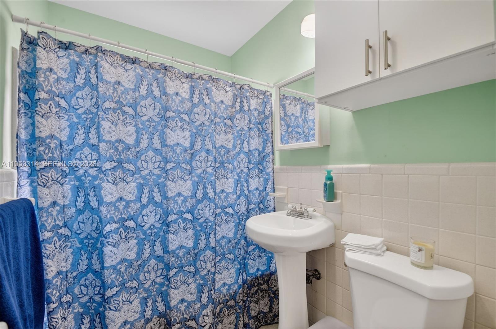 1712 High Ridge Road Lake Worth, FL 33461 - Photo 17 of 43 a bathroom with a sink and a mirror