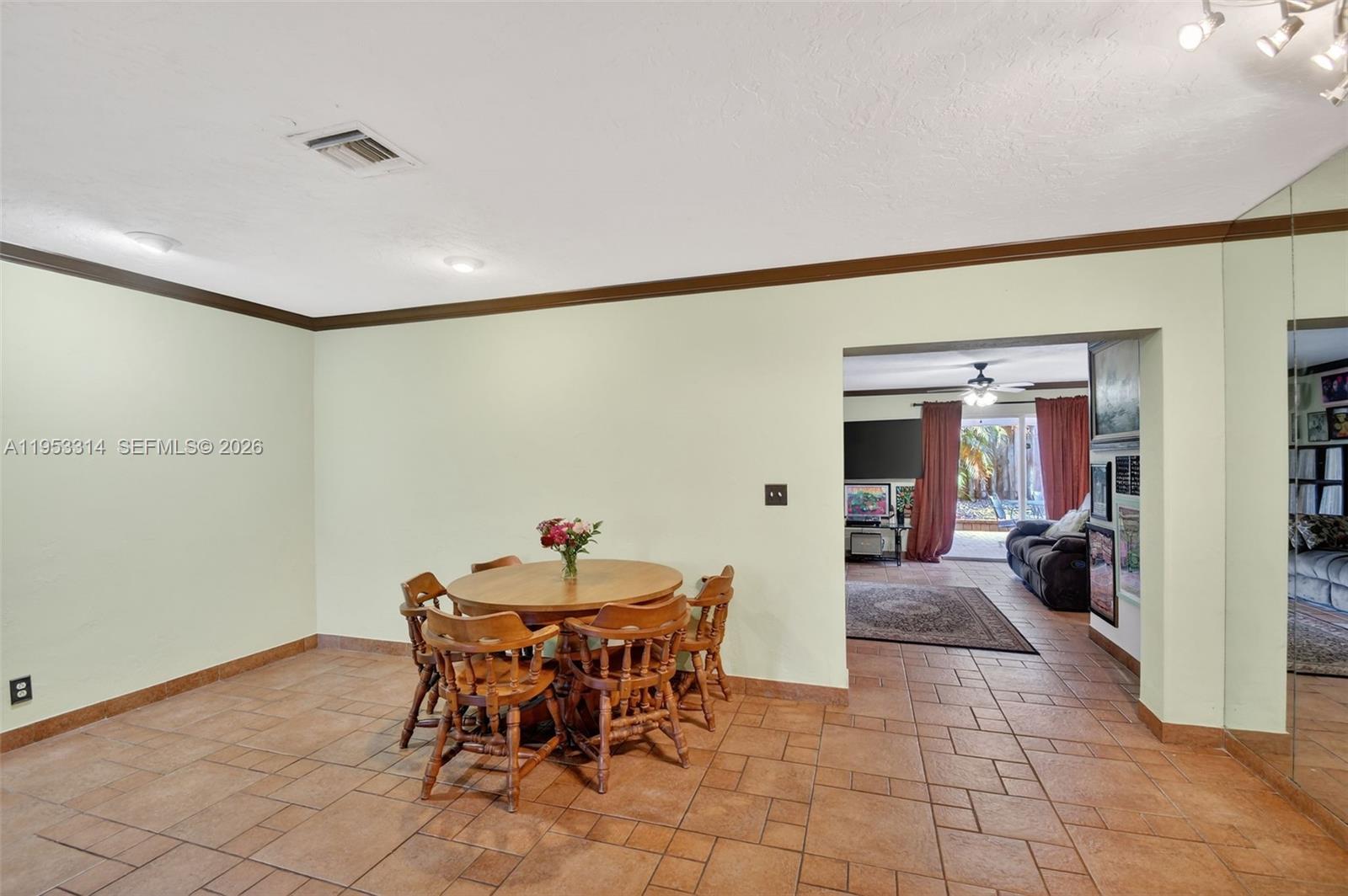 1712 High Ridge Road Lake Worth, FL 33461 - Photo 21 of 43 a view of a dining room with furniture and a chandelier