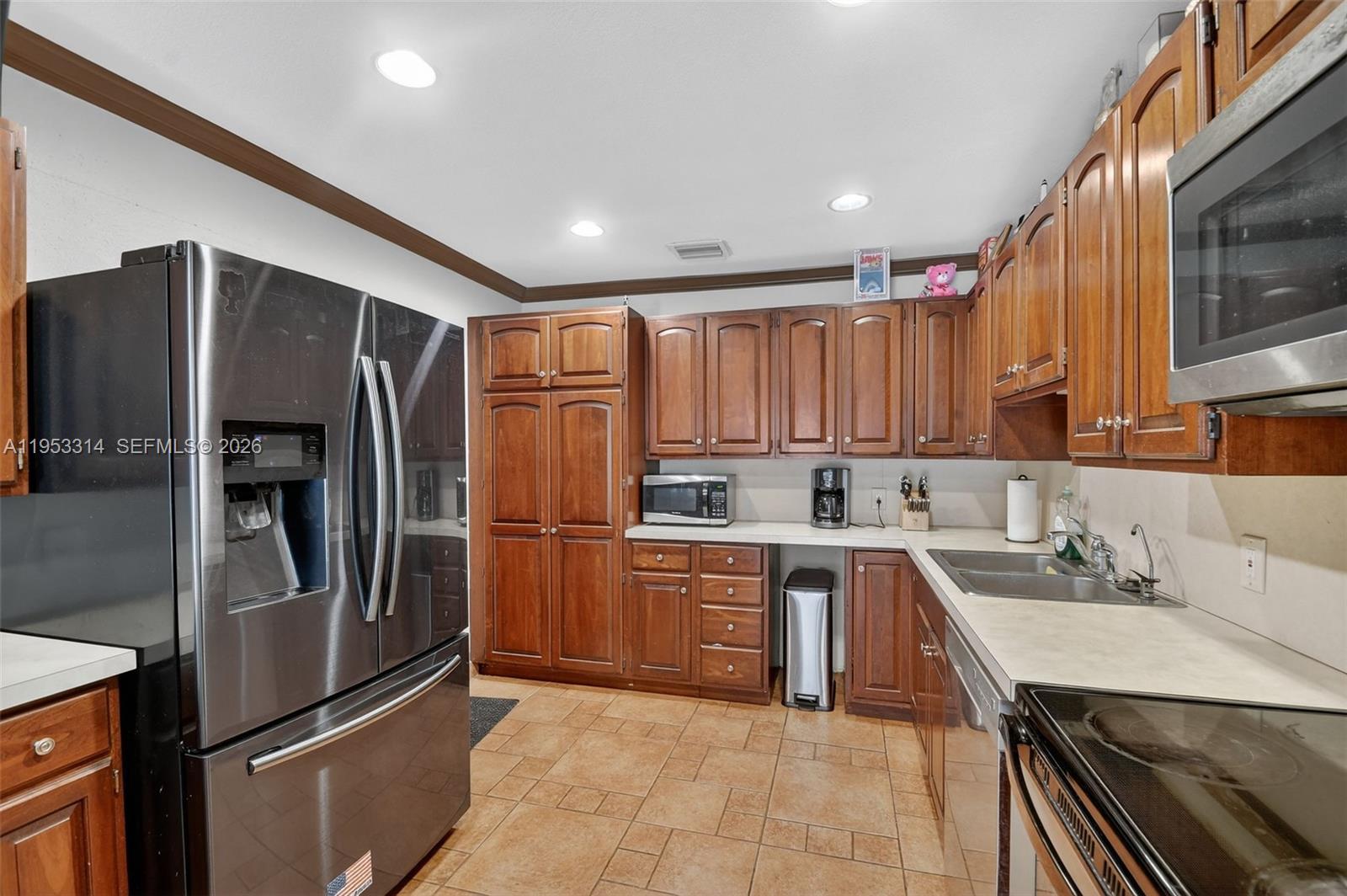 1712 High Ridge Road Lake Worth, FL 33461 - Photo 29 of 43 a kitchen with stainless steel appliances granite countertop a refrigerator a sink and a stove