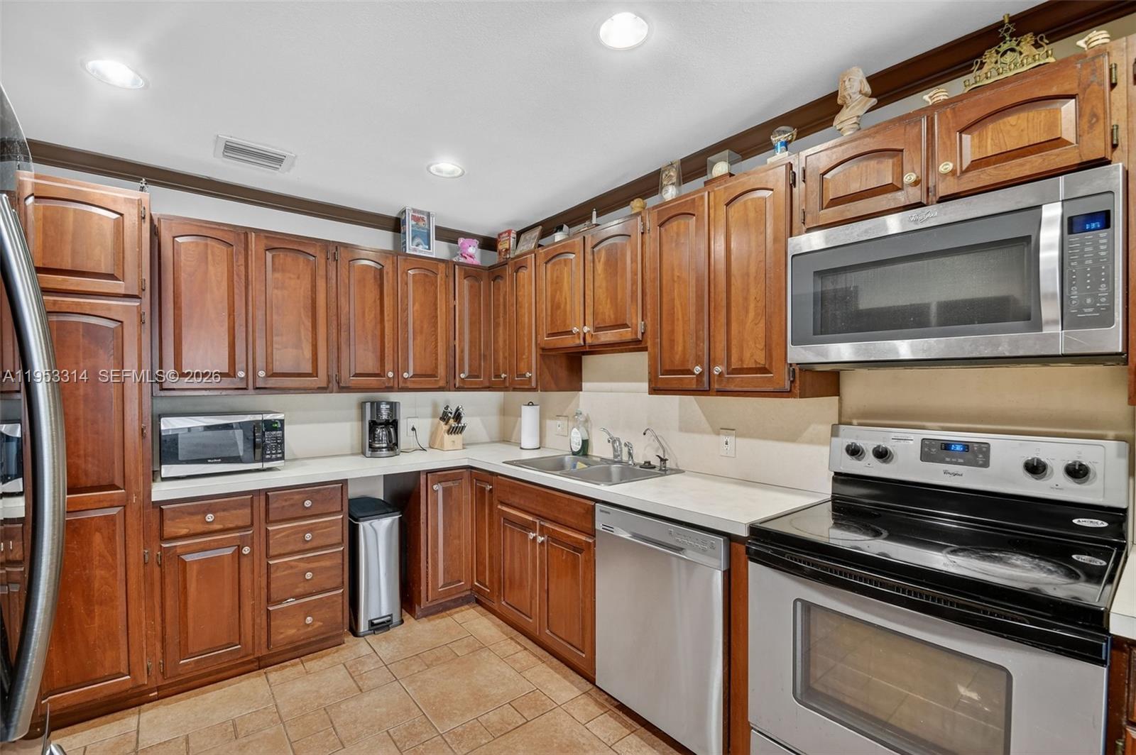 1712 High Ridge Road Lake Worth, FL 33461 - Photo 30 of 43 a kitchen with a sink stove and microwave