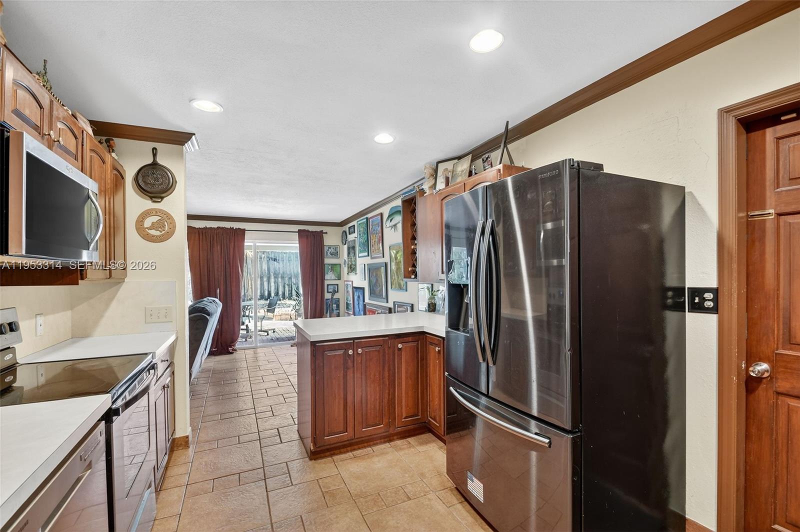1712 High Ridge Road Lake Worth, FL 33461 - Photo 32 of 43 a kitchen with stainless steel appliances granite countertop a refrigerator and a sink