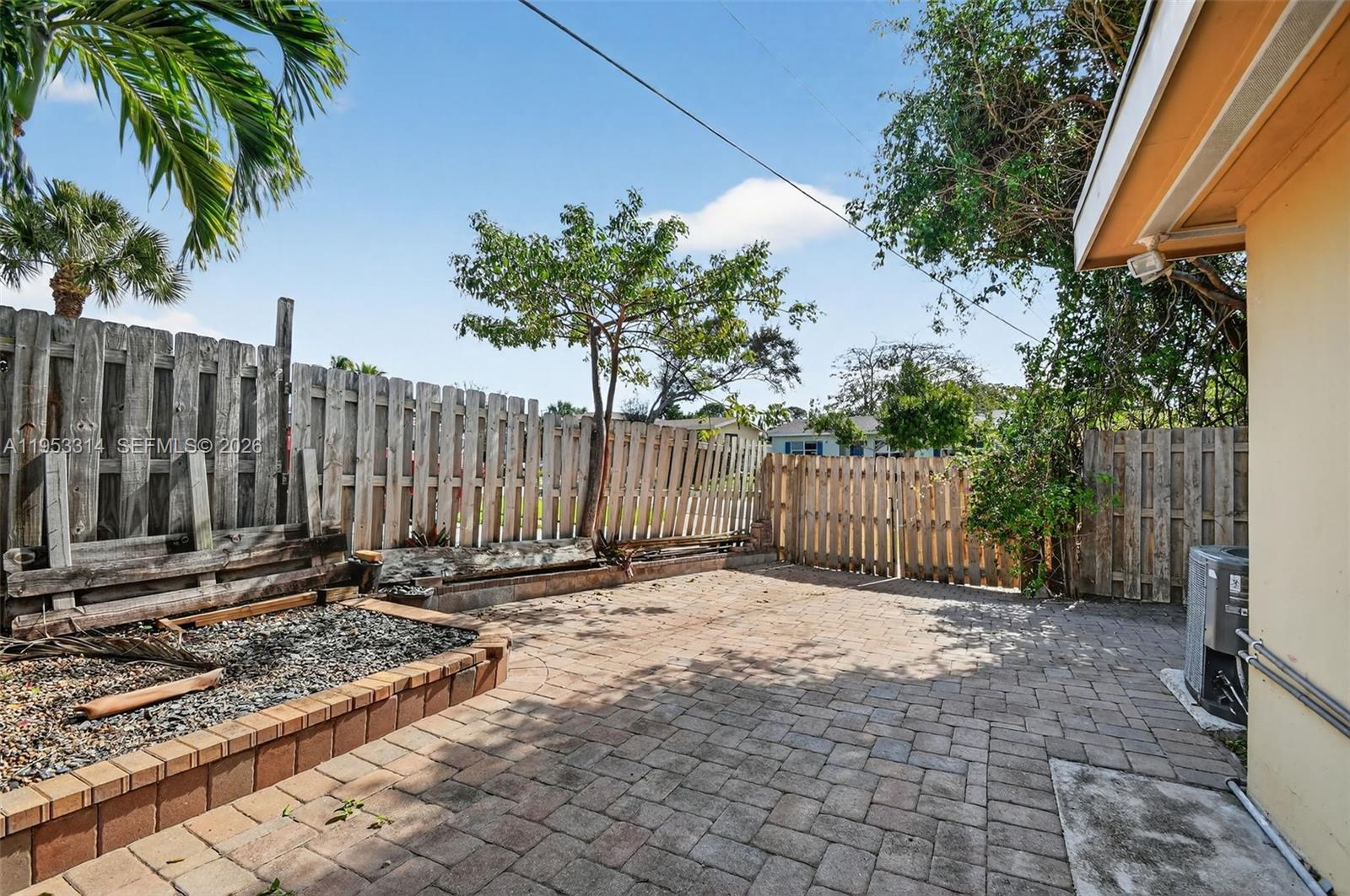1712 High Ridge Road Lake Worth, FL 33461 - Photo 41 of 43 a view of a small yard with wooden fence