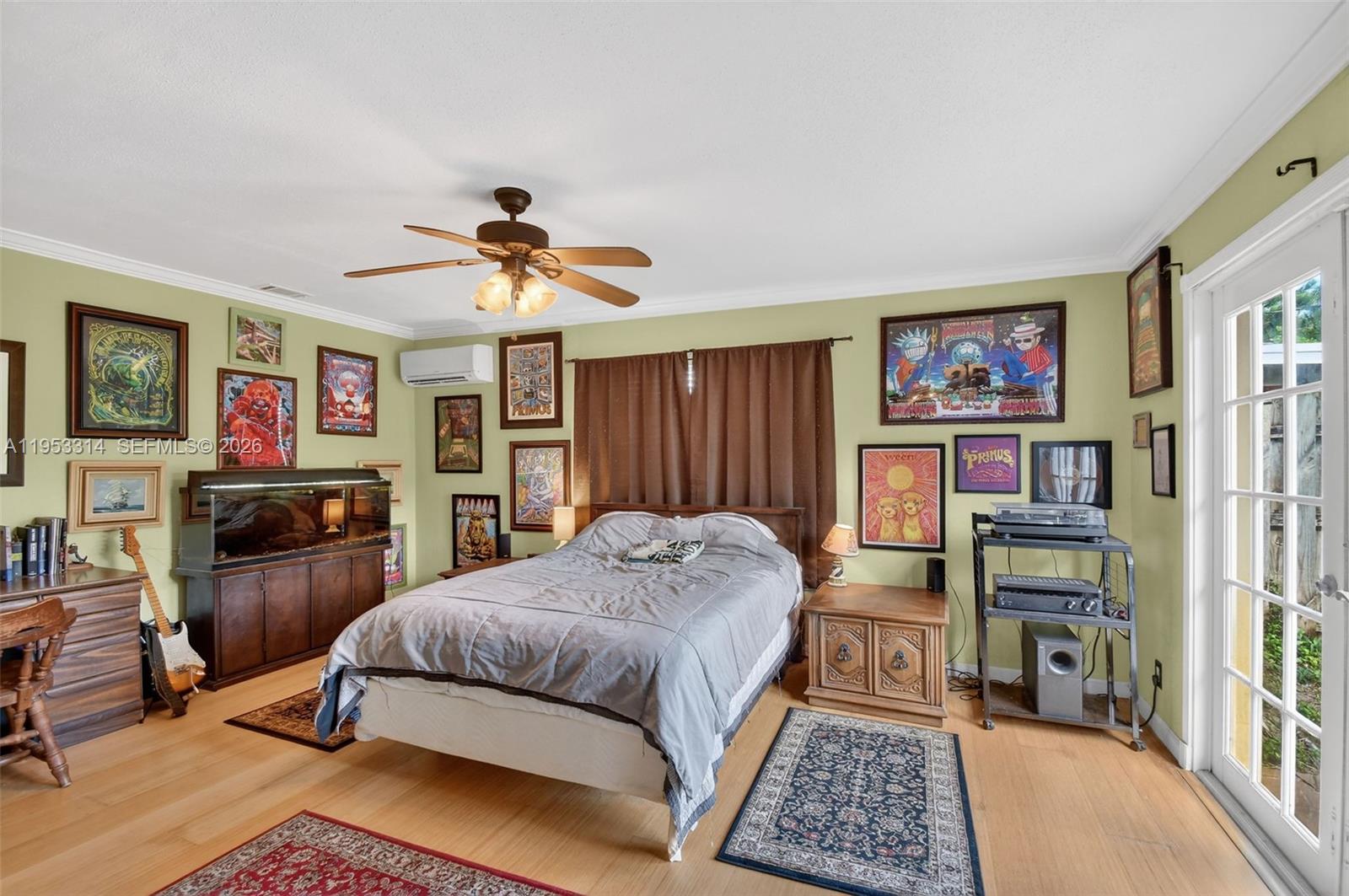 1712 High Ridge Road Lake Worth, FL 33461 - Photo 8 of 43 a bedroom with a bed furniture and a chandelier