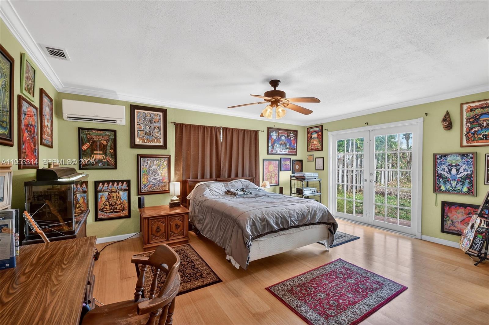 1712 High Ridge Road Lake Worth, FL 33461 - Photo 9 of 43 a spacious bedroom with a bed a dresser and book shelf