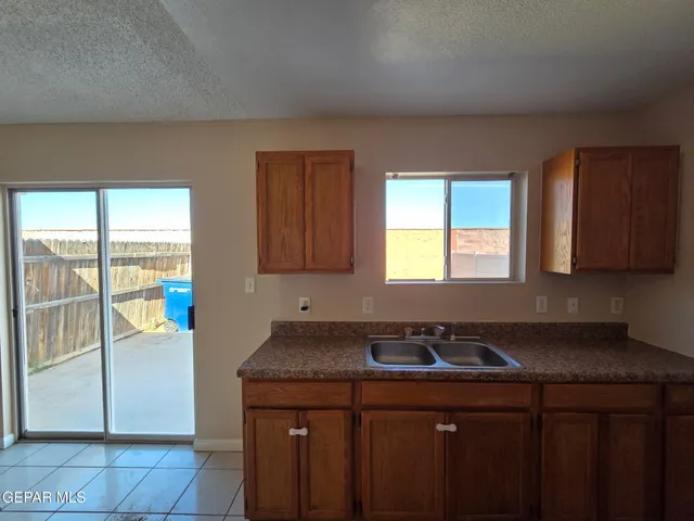 a kitchen with a sink cabinets and a window