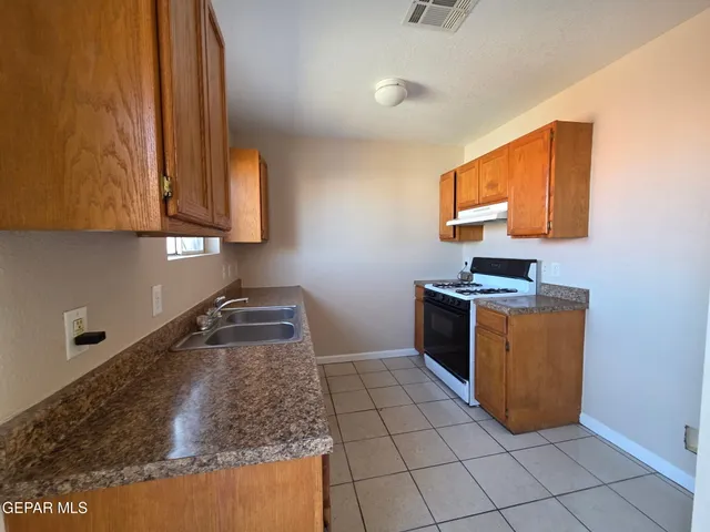 a kitchen with stainless steel appliances granite countertop a sink and cabinets