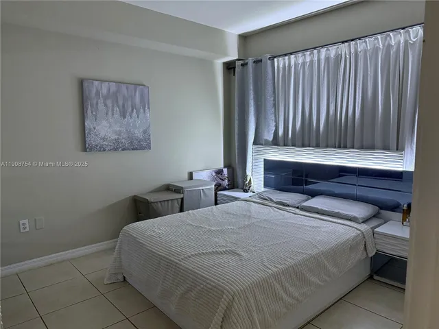 a bedroom with a bed and a wall painting