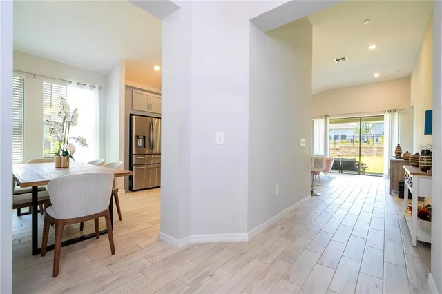 a room that has painting on the wall and a potted plant