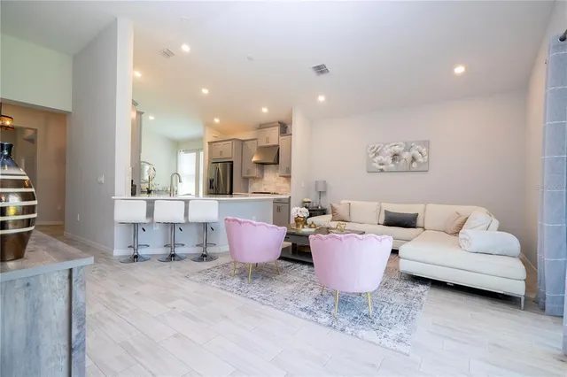 a kitchen with kitchen island granite countertop a sink a stove and a refrigerator