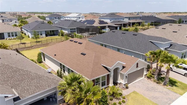 an aerial view of multiple houses with yard