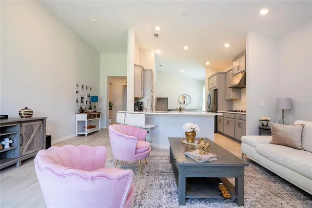 a kitchen with stainless steel appliances a stove a sink a microwave and cabinets