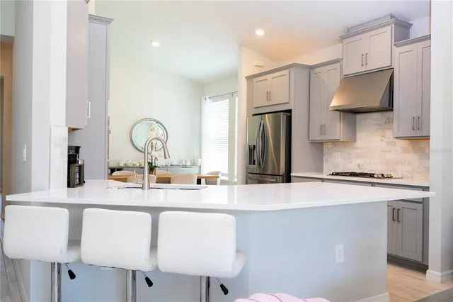 a kitchen with cabinets stainless steel appliances and sink