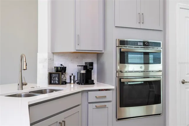 a kitchen with a refrigerator a dining table and chairs