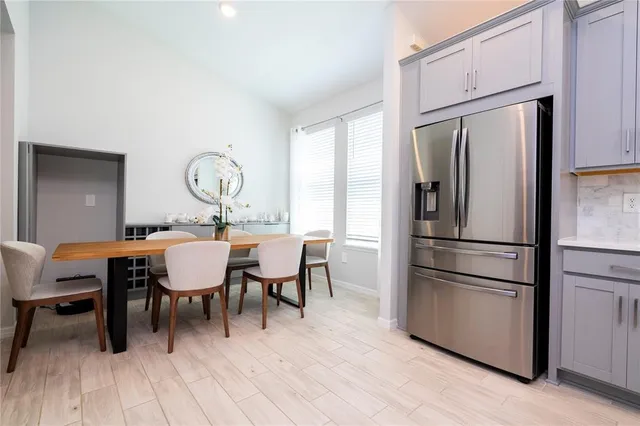 a large bed sitting in a bedroom next to a window