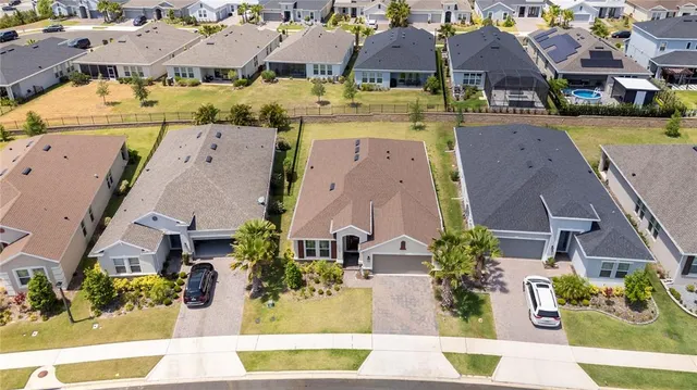 an aerial view of multiple houses with a yard