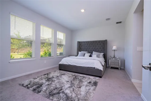 a bathroom with a tub a sink and mirror
