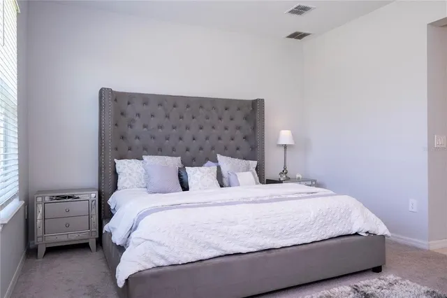 a bedroom with a bed and a table in it