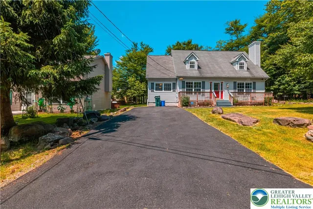 a front view of a house with a yard table and chairs