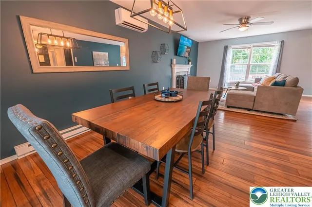 a kitchen with stainless steel appliances a stove a sink a refrigerator and wooden floor