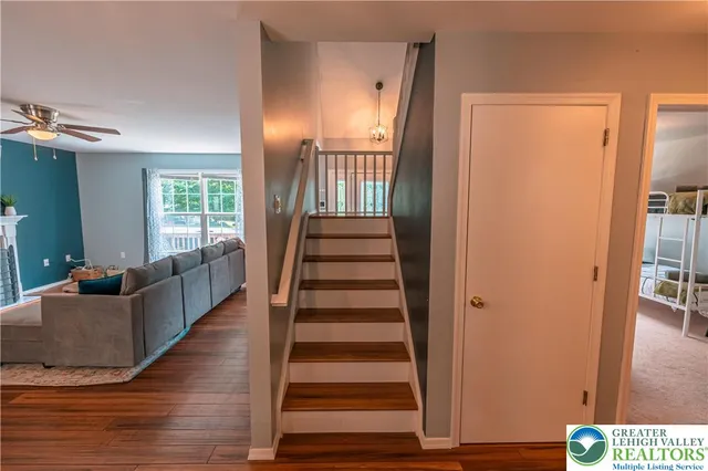 a living room with furniture a flat screen tv and a table