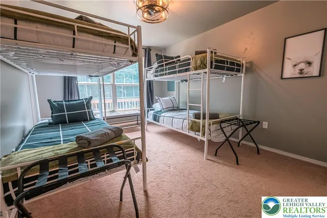 a living room with furniture a flat screen tv and a window