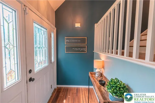 a view of a livingroom with furniture and staircase