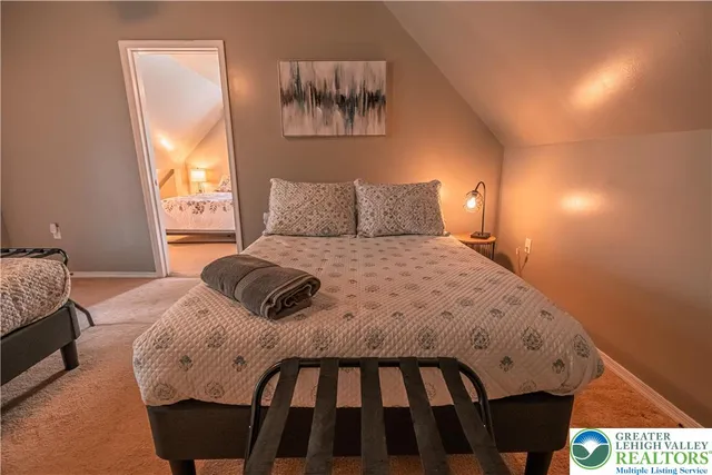 a view of a roof deck with table and chairs under an umbrella