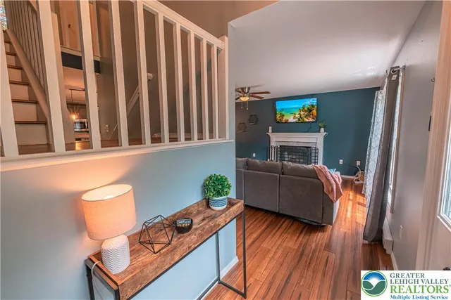 a living room with furniture a fireplace and a flat screen tv