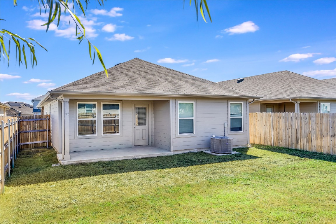 17409 Ginning Court Elgin, TX 78621 - Photo 11 of 13 a view of house with a yard