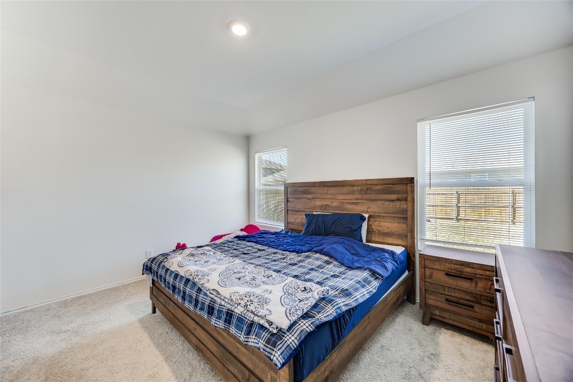 17409 Ginning Court Elgin, TX 78621 - Photo 8 of 13 a bedroom with a bed and a fireplace