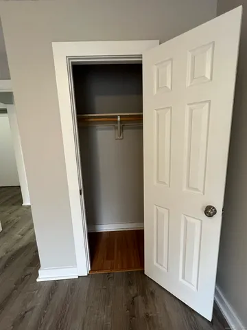 a view of walk in closet with empty racks