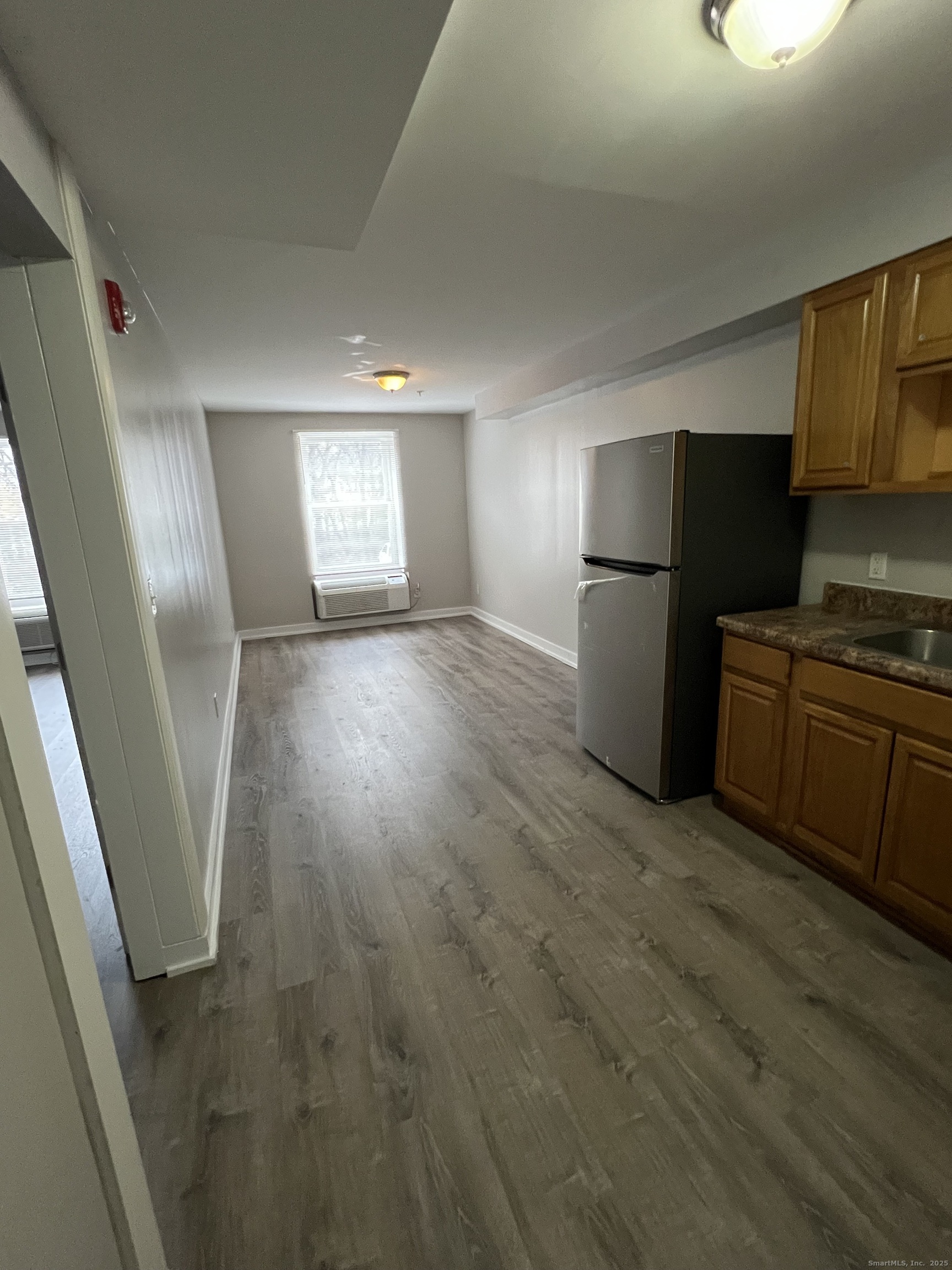 385 Putnam Avenue, Unit 5 Hamden, CT 06517 - Photo 2 of 13 a view of a kitchen with a sink and a refrigerator