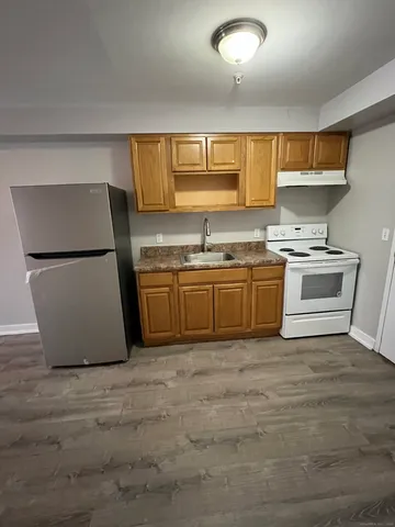 a kitchen with a sink a stove and a refrigerator